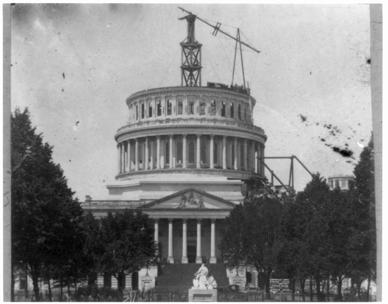 The Capitol dome under construction, with a crane on top of the unfinished drum.